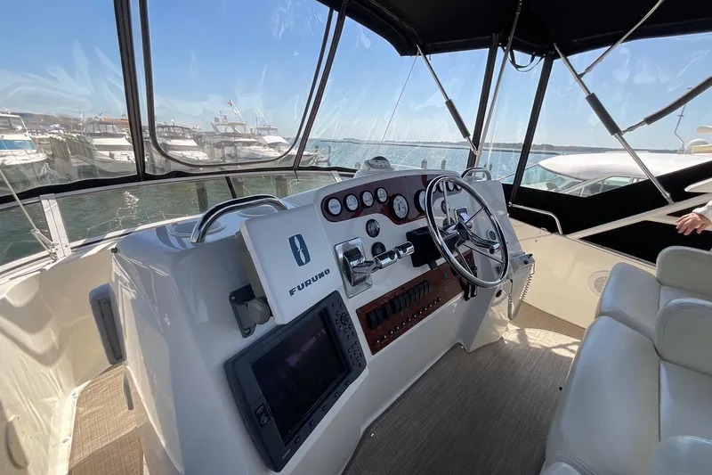 Slide: The Image of Cockpit of 2000 Silverton 392 Motor Yacht with steering wheel and navigation equipment. - 21
