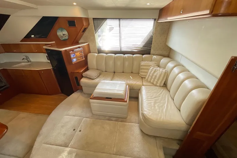 Slide: The Image of Luxurious interior of 2000 Silverton 392 Motor Yacht with plush seating and elegant wood finishes. - 23