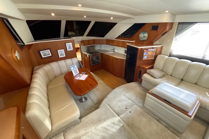 Slide: The Image of Luxurious interior of a 2000 Silverton 392 Motor Yacht with plush seating and kitchenette. - 24