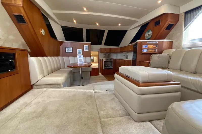 Slide: The Image of Luxurious interior of 2000 Silverton 392 Motor Yacht with plush seating and elegant wood finishes. - 25