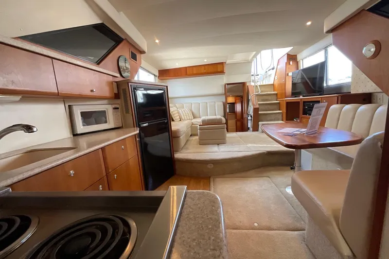 Slide: The Image of Interior of 2000 Silverton 392 Motor Yacht with kitchen, seating, and stairs. - 27