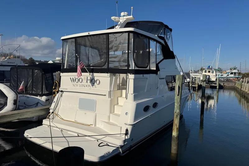 Slide: The Image of 2000 Silverton 392 Motor Yacht docked at marina, clear sky, calm water. - 3
