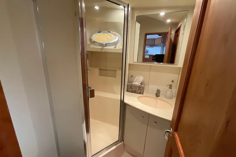 Slide: The Image of Bathroom interior of 2000 Silverton 392 Motor Yacht with shower and vanity. - 30