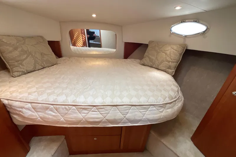 Slide: The Image of Cozy bedroom in 2000 Silverton 392 Motor Yacht with plush bedding and soft lighting. - 33