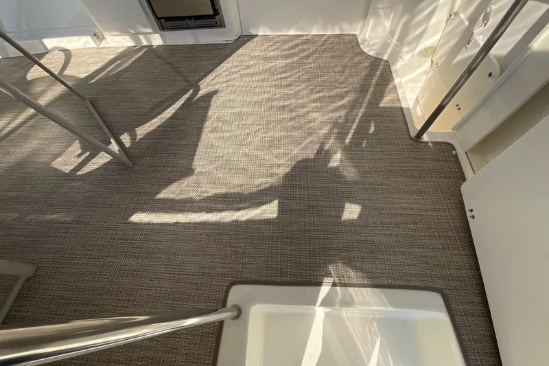 Slide: The Image of Interior view of 2000 Silverton 392 Motor Yacht with carpeted flooring and metal railings. - 4