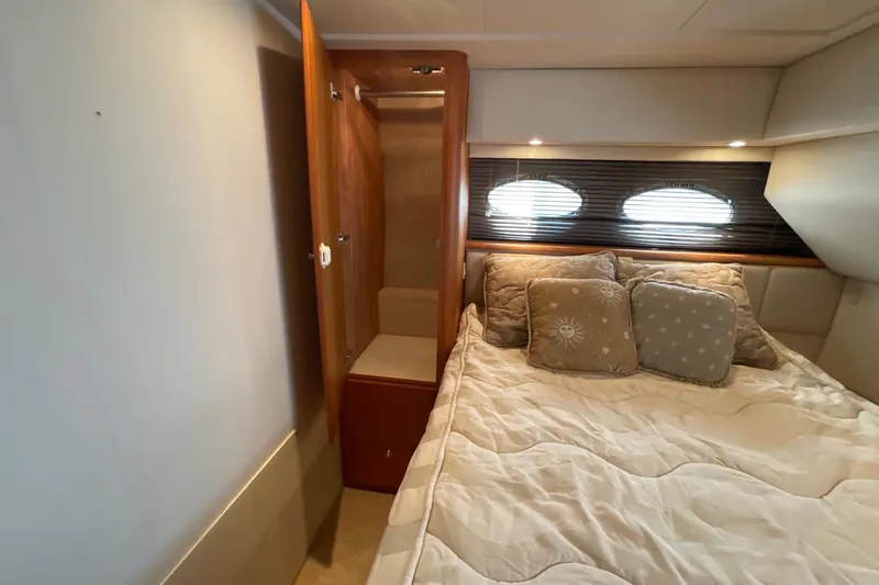 Slide: The Image of Cozy bedroom in 2000 Silverton 392 Motor Yacht with plush bedding and wooden accents. - 43