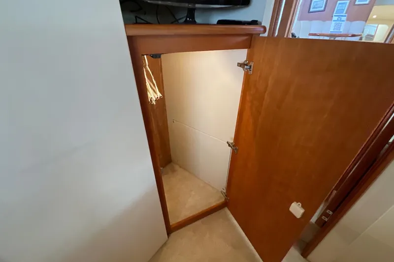 Slide: The Image of Interior view of a 2000 Silverton 392 Motor Yacht, featuring a wooden door and carpeted floor. - 44