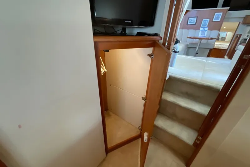 Slide: The Image of Interior of 2000 Silverton 392 Motor Yacht showing stairs and storage area. - 45