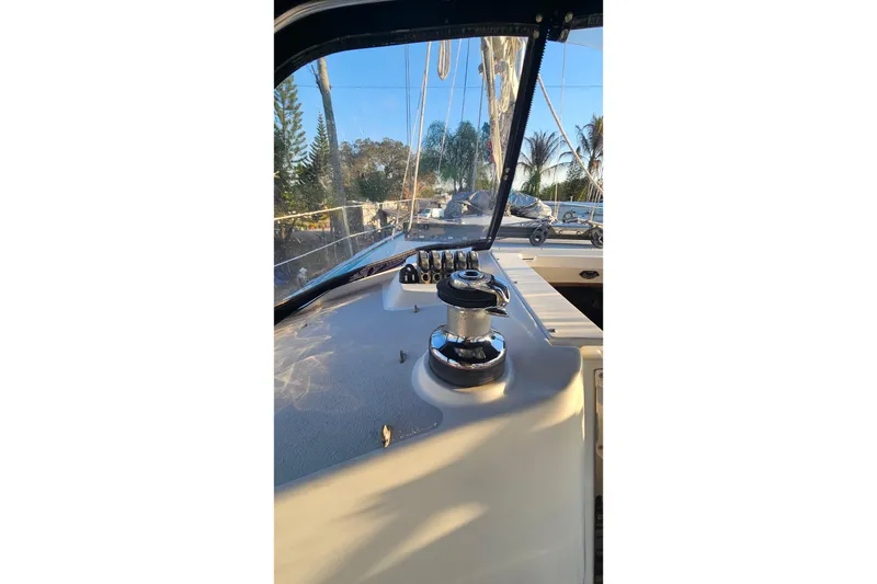 Slide: The Image of Cockpit view of a 2005 Catalina 350 sailboat with winch and clear skies. - 12