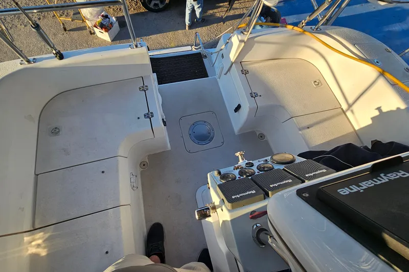 Slide: The Image of Cockpit view of a 2005 Catalina 350 sailboat, showcasing seating and control panels. - 17