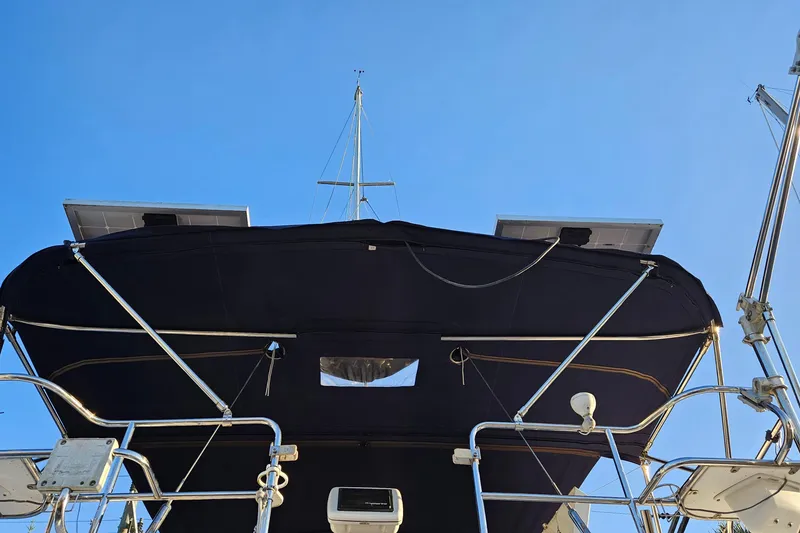 Slide: The Image of Catalina 350 sailboat, 2005 model, featuring solar panels and a bimini top against a clear sky. - 20