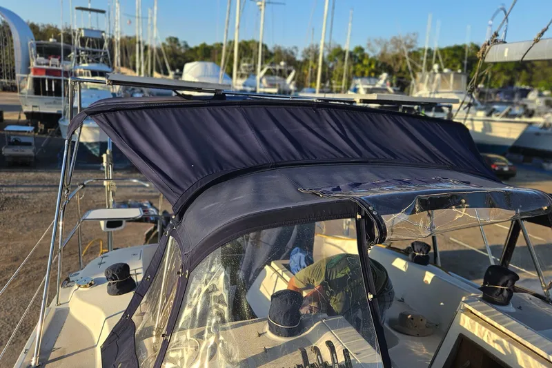 Slide: The Image of Catalina 350 sailboat from 2005 with navy canopy in a marina setting. - 22