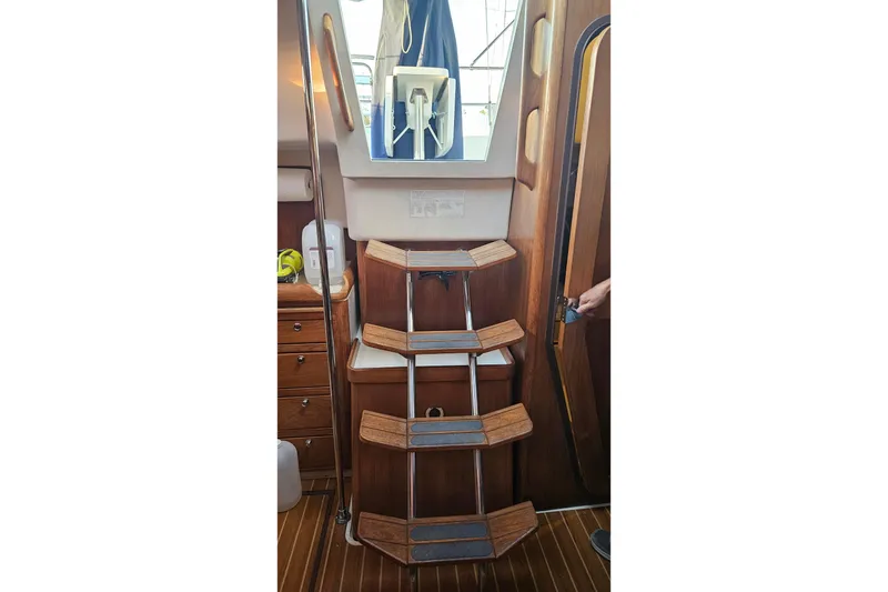 Slide: The Image of Interior of a 2005 Catalina 350 sailboat featuring wooden steps and nautical design. - 23