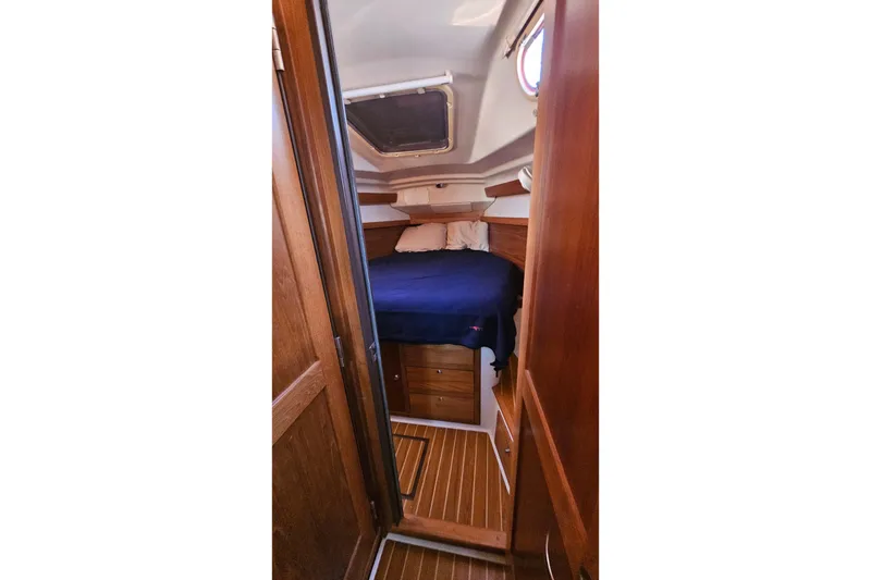 Slide: The Image of Cozy cabin interior of 2005 Catalina 350 sailboat with wooden finish and bedding. - 38