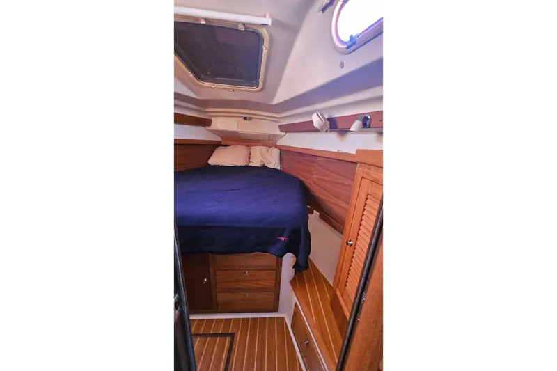 Slide: The Image of Cozy cabin interior of 2005 Catalina 350 sailboat with wooden furnishings and bedding. - 40