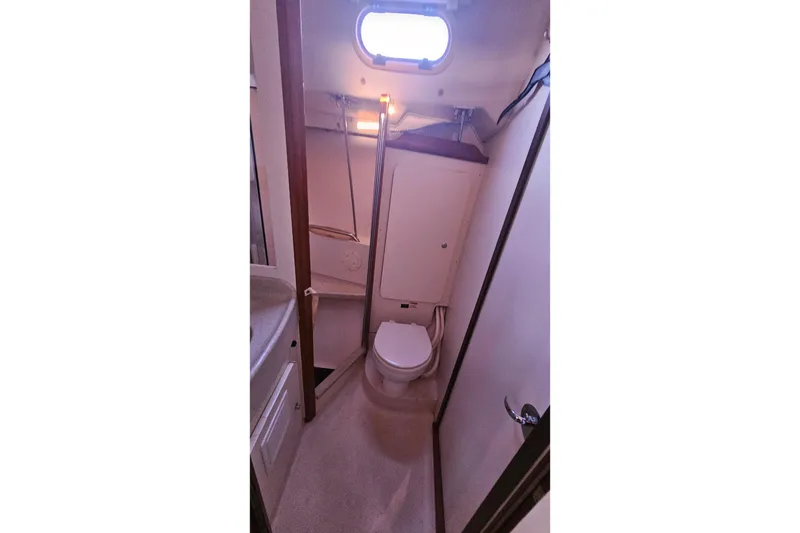Slide: The Image of Interior view of a 2005 Catalina 350 sailboat bathroom with toilet and sink. - 41