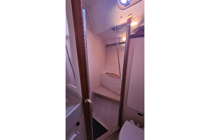 Slide: The Image of Bathroom interior of a 2005 Catalina 350 sailboat, featuring a shower and toilet. - 42