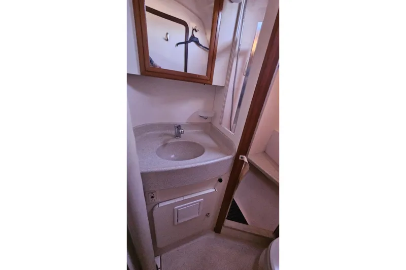 Slide: The Image of Compact bathroom in a 2005 Catalina 350 sailboat, featuring a sink and mirror. - 43