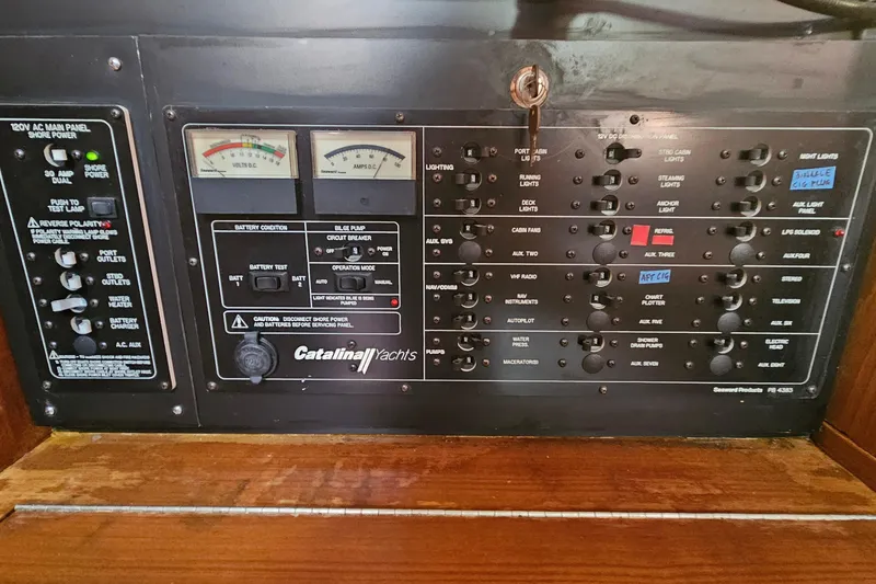 Slide: The Image of Control panel of a 2005 Catalina 350 yacht with various switches and gauges. - 45