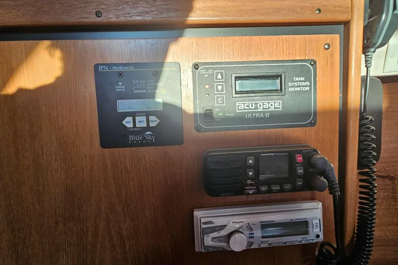 Slide: The Image of Control panel of a 2005 Catalina 350 sailboat with monitoring systems and radio equipment. - 46
