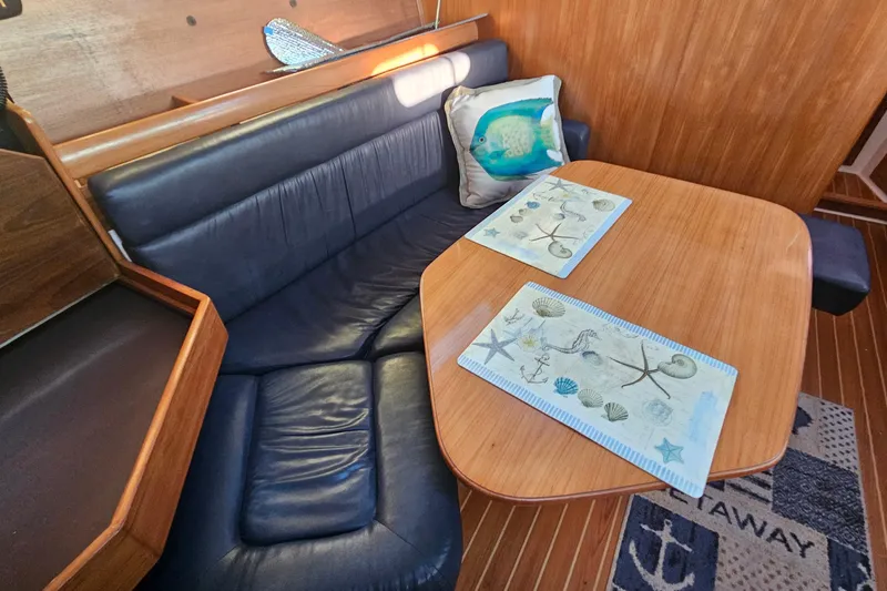 Slide: The Image of Interior of a 2005 Catalina 350 sailboat with a cozy dining area. - 49