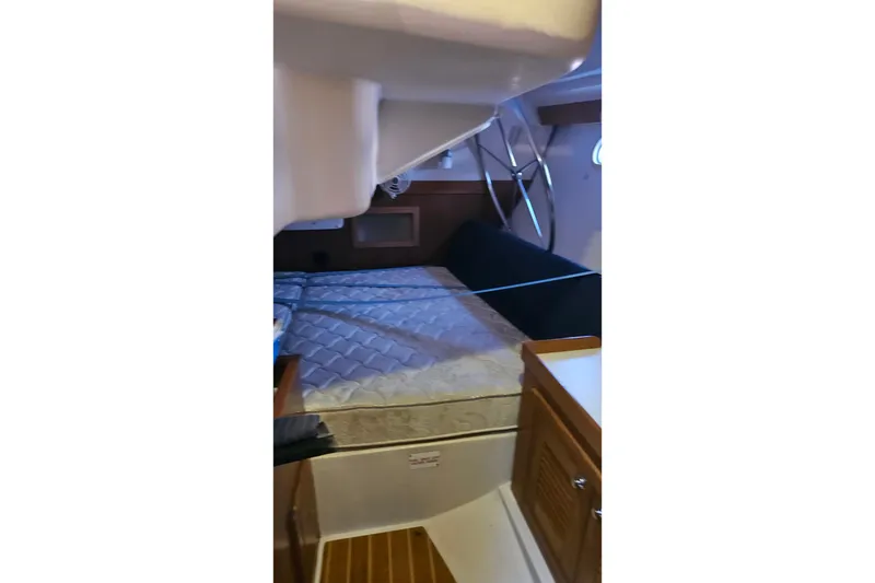 Slide: The Image of Interior cabin of a 2005 Catalina 350 sailboat with bed and wooden cabinetry. - 50