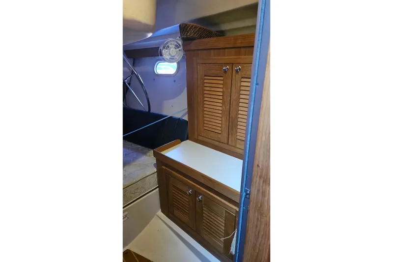 Slide: The Image of Interior of 2005 Catalina 350 sailboat with wooden cabinets and small fan. - 51