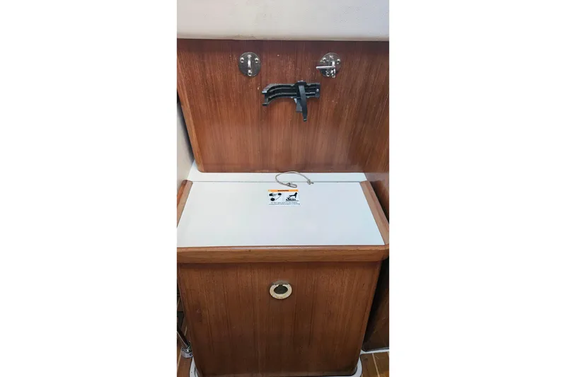 Slide: The Image of Wooden cabinet with a foldable faucet in a 2005 Catalina 350 sailboat. - 52