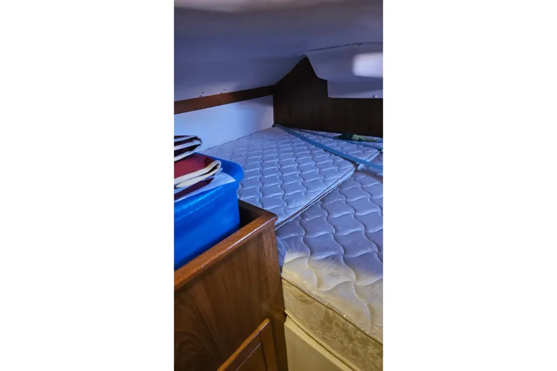 Slide: The Image of Interior cabin of a 2005 Catalina 350 sailboat with mattress and storage. - 56
