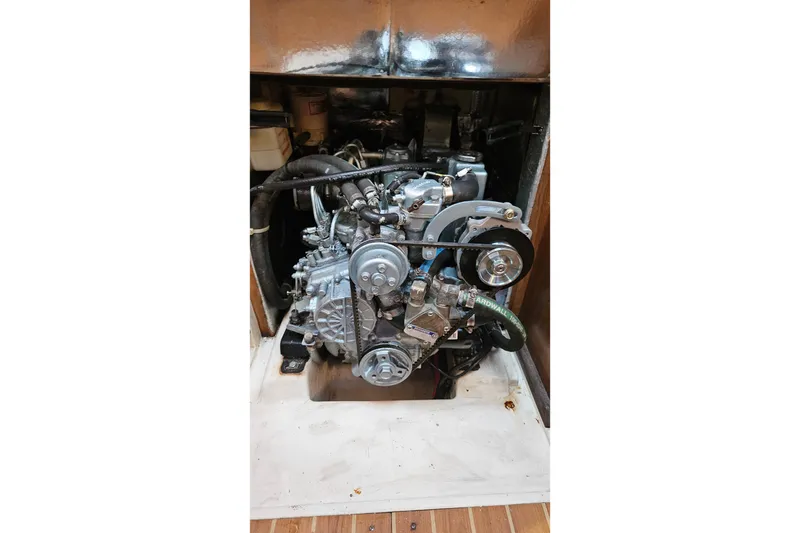 Slide: The Image of Engine compartment of a 2005 Catalina 350 sailboat, showcasing mechanical components. - 59