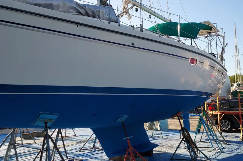 Slide: The Image of Catalina 350 MkII 2005 sailboat on stands, blue hull, marina setting. - 6