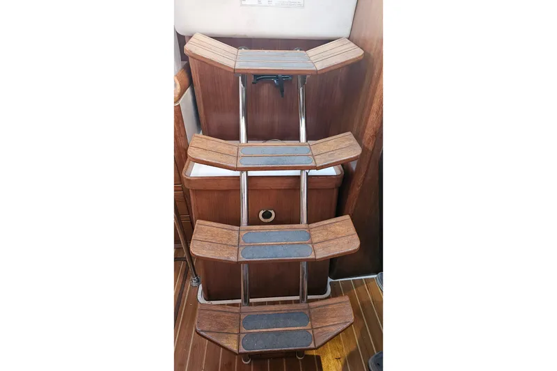 Slide: The Image of Wooden steps with metal rails inside a 2005 Catalina 350 yacht. - 60