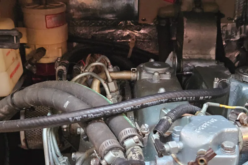 Slide: The Image of Engine compartment of a 2005 Catalina 350 sailboat, showing hoses and components. - 64