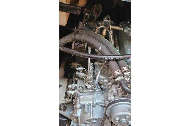 Slide: The Image of Engine compartment of a 2005 Catalina 350 sailboat, showing hoses and mechanical components. - 65