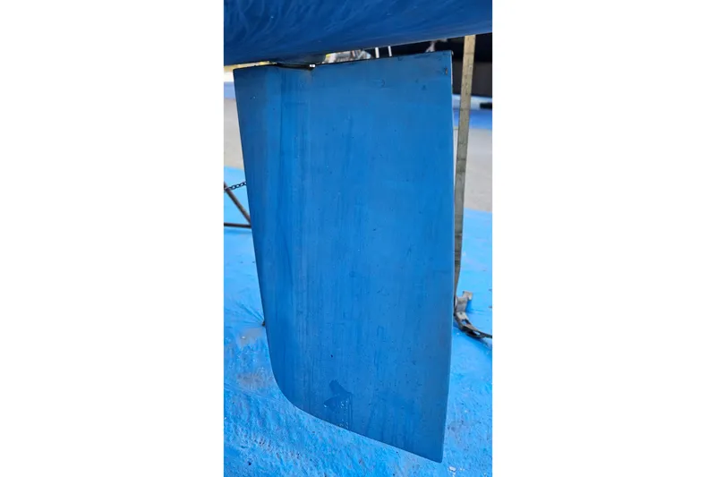 Slide: The Image of Rudder of a 2005 Catalina 350 sailboat, painted blue, on a stand. - 66