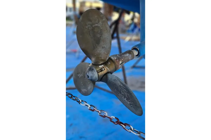 Slide: The Image of Propeller of a 2005 Catalina 350 sailboat on a blue background. - 68