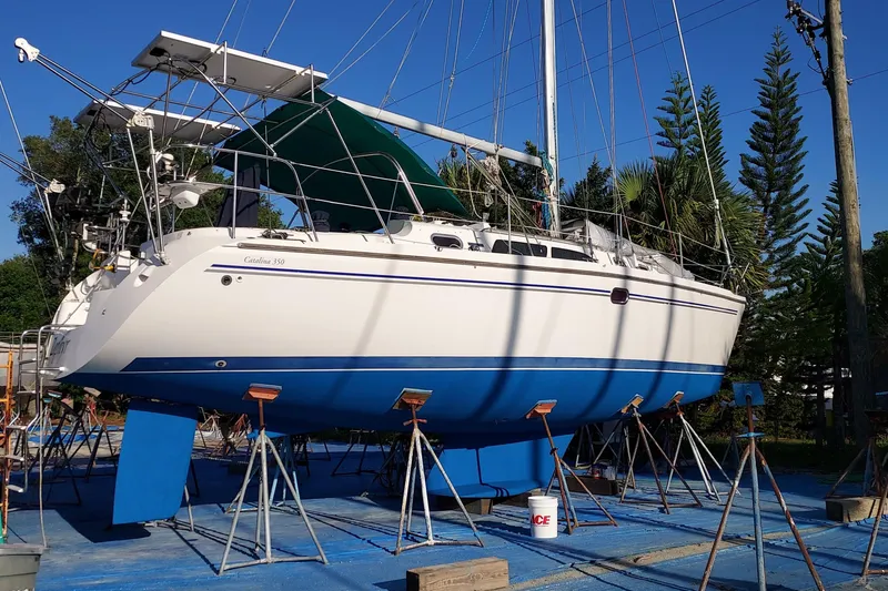 Slide: The Image of 2005 Catalina 350 MkII sailboat on stands, blue hull, outdoor setting. - 70