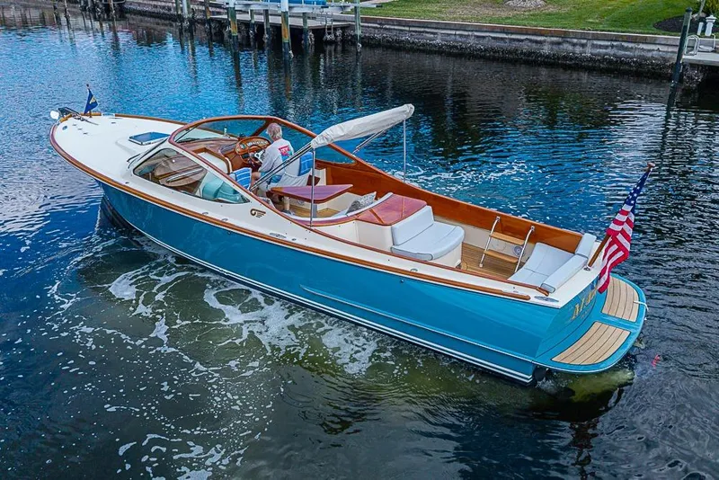 The Image of 2004 Hinckley Talaria 29 R boat cruising on a scenic waterway, certified pre-owned. - 0