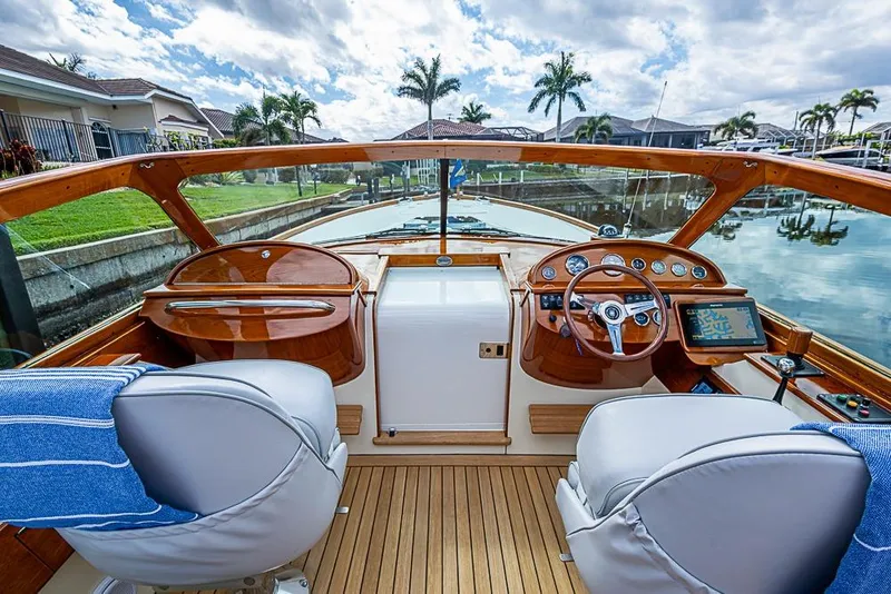 Slide: The Image of 2004 Hinckley Talaria 29 R boat interior with elegant wood finish and plush seating. - 5