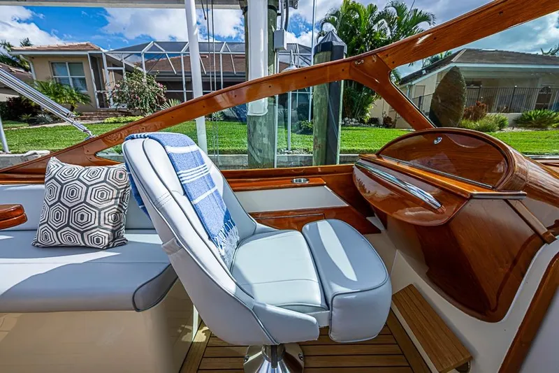 Slide: The Image of 2004 Hinckley Talaria 29 R boat interior with wooden dashboard and leather seating. - 7