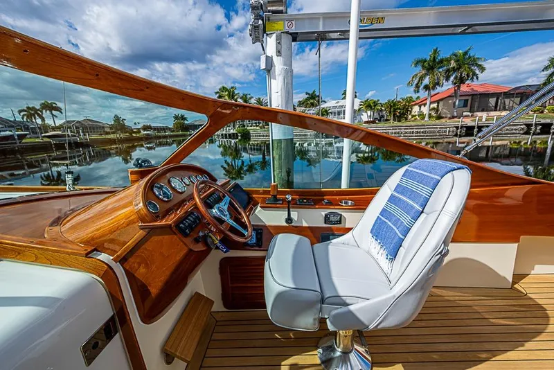 Slide: The Image of 2004 Hinckley Talaria 29 R boat interior with wooden dashboard and leather seats. - 6