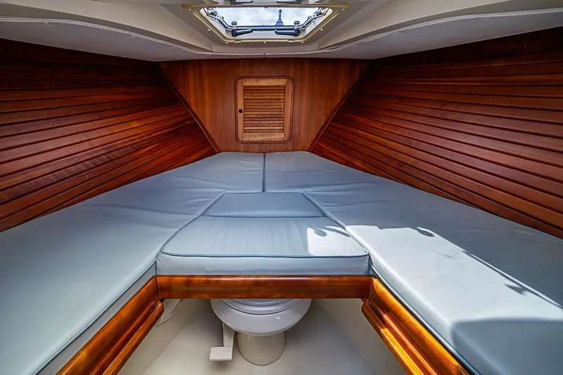 Slide: The Image of 2004 Hinckley Talaria 29 R boat cockpit with wooden dashboard and navigation system. - 9