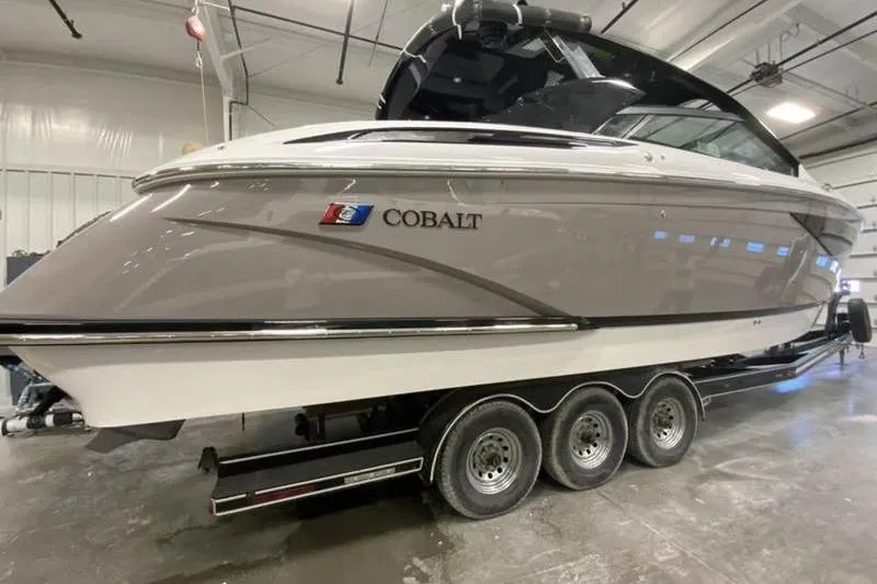 Slide: The Image of 2022 Cobalt A36BR boat on a trailer in a garage setting. - 2