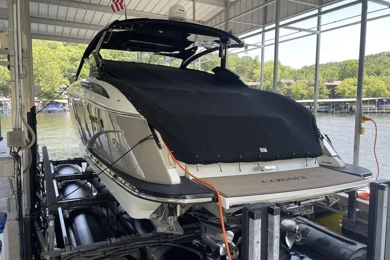 Slide: The Image of 2022 Cobalt A36BR boat docked under a covered marina, rear view. - 6