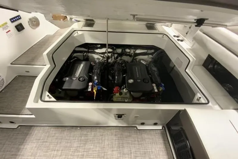 Slide: The Image of 2022 Cobalt A36BR boat engine compartment with dual engines, open hatch view. - 7