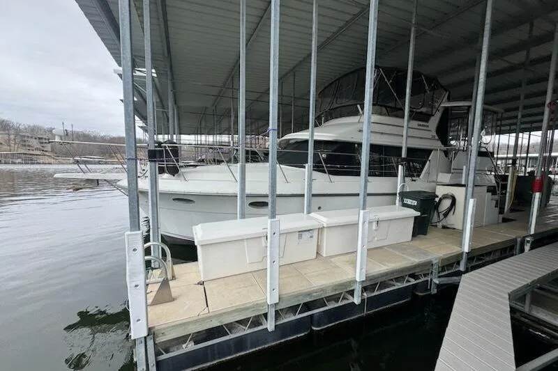 The Image of 1992 Carver 38 Aft Cabin Motor Yacht docked in covered marina. - 0