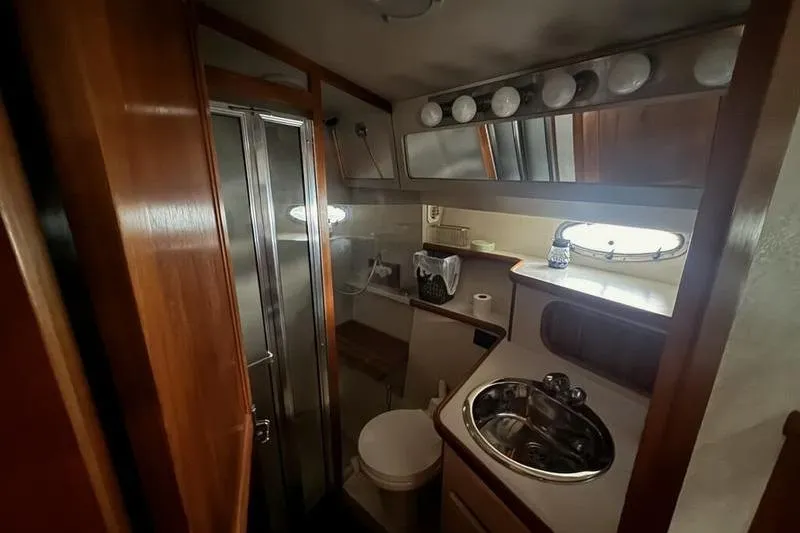 Slide: The Image of 1992 Carver 38 Aft Cabin Motor Yacht bathroom with shower, sink, and mirror. - 11