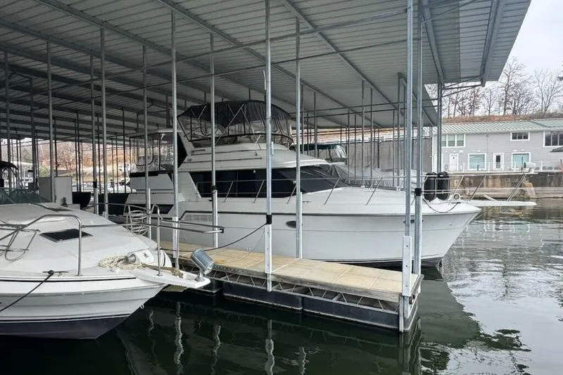 Slide: The Image of 1992 Carver 38 Aft Cabin Motor Yacht docked in covered marina. - 13