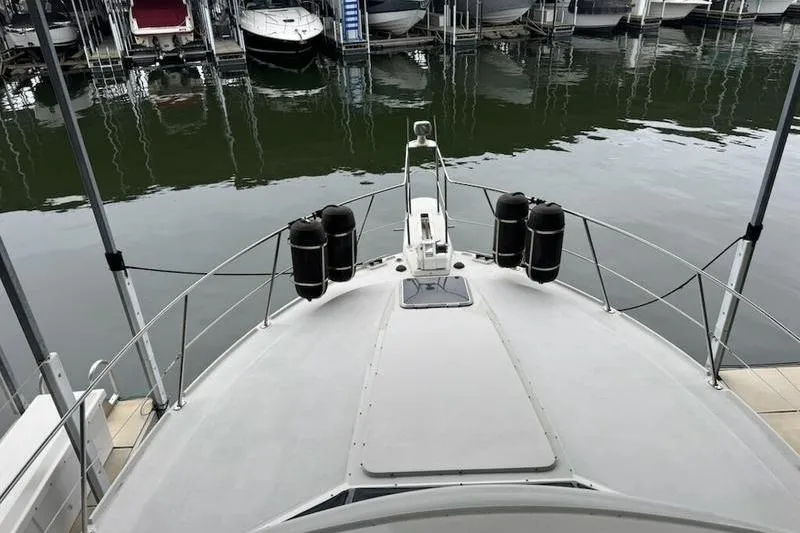 Slide: The Image of 1992 Carver 38 Aft Cabin Motor Yacht docked at marina, view from bow. - 6