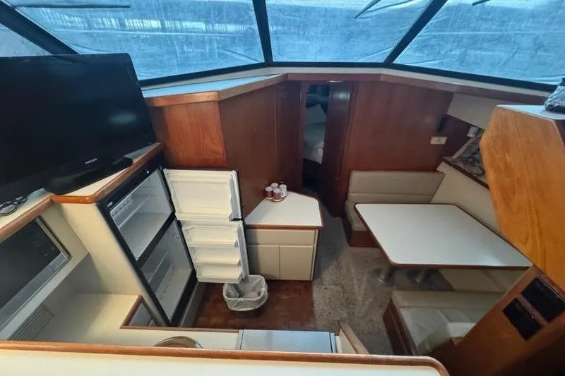 Slide: The Image of Interior of 1992 Carver 38 Aft Cabin Motor Yacht with kitchen and dining area. - 12